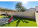 Landscaped backyard with covered patio and playset at 3123 Logan Ave, North Las Vegas, NV 89032