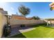 Landscaped backyard with artificial turf, patio, and play area at 3123 Logan Ave, North Las Vegas, NV 89032