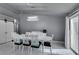 Bright dining room with white table and chairs, and a modern light fixture at 3123 Logan Ave, North Las Vegas, NV 89032