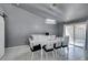 Bright dining room with white table and chairs, and access to patio at 3123 Logan Ave, North Las Vegas, NV 89032