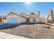 Front view of a single-story house with a landscaped yard at 3123 Logan Ave, North Las Vegas, NV 89032