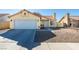 Single-story house with a two-car garage and desert landscaping at 3123 Logan Ave, North Las Vegas, NV 89032