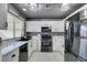 Modern kitchen with white cabinets, stainless steel appliances, and a black sink at 3123 Logan Ave, North Las Vegas, NV 89032