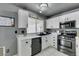 Modern kitchen with white cabinets, stainless steel appliances, and a window at 3123 Logan Ave, North Las Vegas, NV 89032