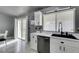 Kitchen features white shaker cabinets, stainless steel appliances, and a black farm sink at 3123 Logan Ave, North Las Vegas, NV 89032