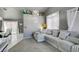 Spacious living room featuring a large sectional sofa and grey walls at 3123 Logan Ave, North Las Vegas, NV 89032