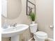 Stylish powder room with pedestal sink and toilet at 3296 Palindrome Ave, Henderson, NV 89044