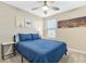 Comfortable bedroom featuring a blue comforter and city skyline art at 3296 Palindrome Ave, Henderson, NV 89044