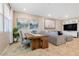 Open concept dining area with wood table, living room view, and large windows at 3296 Palindrome Ave, Henderson, NV 89044