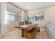 Dining area with rustic wood table, bench seating, and stylish artwork at 3296 Palindrome Ave, Henderson, NV 89044