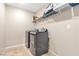 Laundry room with washer, dryer and overhead shelving at 3296 Palindrome Ave, Henderson, NV 89044