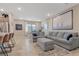 Living room with sectional sofa, ottoman, and large piece of artwork at 3296 Palindrome Ave, Henderson, NV 89044