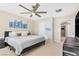 Bright main bedroom with king bed, ceiling fan, and large window at 3296 Palindrome Ave, Henderson, NV 89044