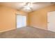 Bedroom with ceiling fan, carpeting, and access to a private balcony at 3320 S Fort Apache Rd # 125, Las Vegas, NV 89117