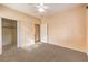 Bedroom with ceiling fan, carpet, and mirrored closet doors at 3320 S Fort Apache Rd # 125, Las Vegas, NV 89117