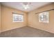 Bright bedroom with ceiling fan, carpet, and two large windows at 3320 S Fort Apache Rd # 125, Las Vegas, NV 89117