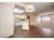 Open kitchen with breakfast bar, hardwood floors, and white cabinets at 3320 S Fort Apache Rd # 125, Las Vegas, NV 89117