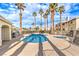 Community pool area boasts tall palm trees, a hot tub, lounge area and beautiful landscaping for relaxation at 3320 S Fort Apache Rd # 125, Las Vegas, NV 89117