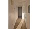 Hallway with light wood-look flooring and access to laundry area at 3425 E Russell Rd # 265, Las Vegas, NV 89120