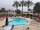 Community pool with palm trees and patio furniture at 3425 E Russell Rd # 265, Las Vegas, NV 89120