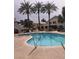 Community pool with lounge chairs and palm trees at 3425 E Russell Rd # 265, Las Vegas, NV 89120