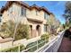 Tan two-story townhome with walkway and landscaping at 3820 Wiggins Bay St # 201, Las Vegas, NV 89129