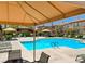 Community pool with lounge chairs and shade structures at 3820 Wiggins Bay St # 201, Las Vegas, NV 89129