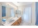 Bathroom featuring a vanity with dual sinks and a large mirror with decorative lighting at 433 Jubilation Dr, Las Vegas, NV 89145