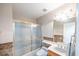 Bright bathroom featuring a shower-tub combination with glass doors and modern fixtures at 433 Jubilation Dr, Las Vegas, NV 89145