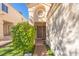 Inviting front entrance with a security door, mature landscaping, and a unique architectural design at 433 Jubilation Dr, Las Vegas, NV 89145