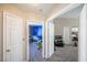 Open hallway showcasing access to carpeted bedrooms and a common area with neutral paint at 433 Jubilation Dr, Las Vegas, NV 89145