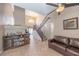 Bright living room featuring a fireplace, open staircase, tile flooring, and seamless flow to other living spaces at 433 Jubilation Dr, Las Vegas, NV 89145