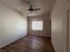 Bedroom with ceiling fan, wood-look flooring, and window at 4419 S Glory Vine Ln, Pahrump, NV 89061