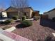 Single-story house with two-car garage,landscaped yard, and desert landscaping at 4419 S Glory Vine Ln, Pahrump, NV 89061