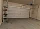 Garage with automatic door opener and shelving unit at 4419 S Glory Vine Ln, Pahrump, NV 89061