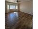 Spacious living room with wood-look flooring and large windows at 4419 S Glory Vine Ln, Pahrump, NV 89061