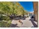 Landscaped backyard with gravel, trees and patio area at 4705 Bersaglio St, Las Vegas, NV 89135