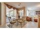 Casual dining area with glass-top table and access to the backyard at 4705 Bersaglio St, Las Vegas, NV 89135