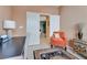 Bright home office with an orange accent chair and built in shelving at 4705 Bersaglio St, Las Vegas, NV 89135