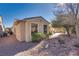 Exterior view of home with light colored walls and rock landscaping at 4705 Bersaglio St, Las Vegas, NV 89135