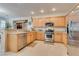 Spacious kitchen with light wood cabinets, stainless steel appliances, and granite countertops at 4705 Bersaglio St, Las Vegas, NV 89135