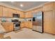 Bright kitchen featuring light wood cabinets, stainless steel appliances, and granite countertops at 4705 Bersaglio St, Las Vegas, NV 89135