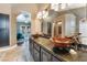 Elegant bathroom with double vanities, granite countertops, and a large mirror at 478 Spanish View Ln, Las Vegas, NV 89110