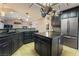 Spacious kitchen with island, granite countertops, and dark wood cabinets at 478 Spanish View Ln, Las Vegas, NV 89110