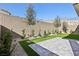 Landscaped backyard with artificial turf and a block wall at 4973 Sandline Ct, Las Vegas, NV 89135