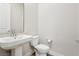 Clean bathroom with pedestal sink and toilet at 4973 Sandline Ct, Las Vegas, NV 89135