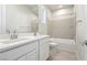 Bathroom with double vanity, bathtub and neutral tile at 4973 Sandline Ct, Las Vegas, NV 89135