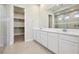 Bathroom boasts double vanity, large mirror, and glass shower at 4973 Sandline Ct, Las Vegas, NV 89135