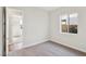 Spacious bedroom with neutral walls and carpet flooring, plus a view of another room at 4973 Sandline Ct, Las Vegas, NV 89135