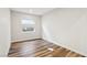 Well-lit bedroom with wood-look floors and windows at 4973 Sandline Ct, Las Vegas, NV 89135